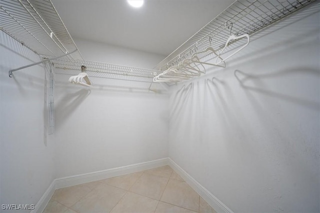 spacious closet with light tile patterned floors