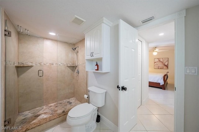 ensuite bathroom with toilet, visible vents, baseboards, a shower stall, and tile patterned floors