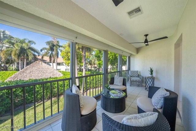 sunroom with ceiling fan and visible vents