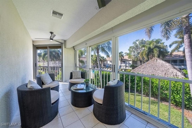 sunroom with visible vents and a ceiling fan