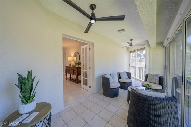 sunroom with a ceiling fan, french doors, and visible vents