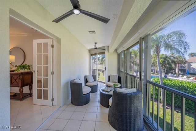 sunroom featuring ceiling fan, french doors, and visible vents