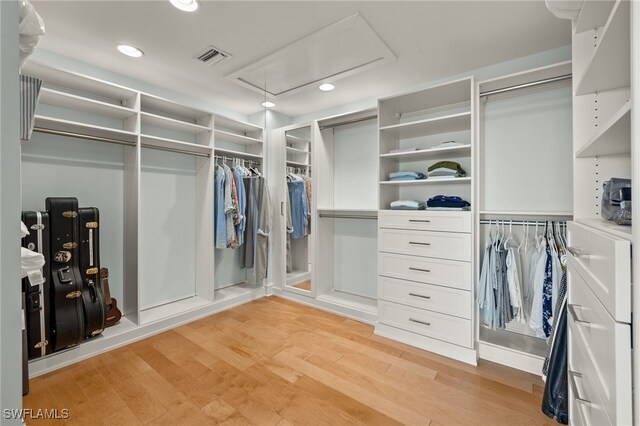 411 Bella Vista Way E, Sanibel, FL 33957 - walk in closet featuring attic access and light wood-style flooring