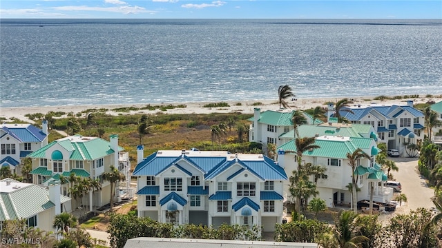 bird's eye view with a water view and a beach view