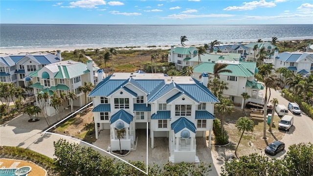 drone / aerial view featuring a water view and a beach view