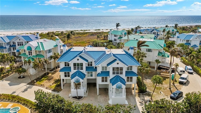 aerial view with a water view and a view of the beach