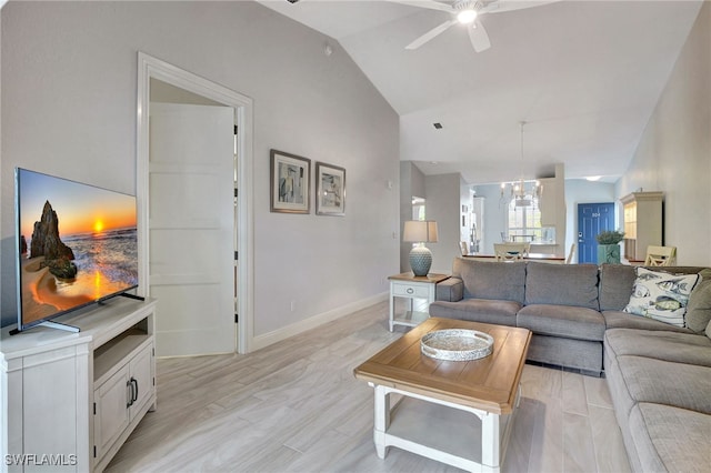 living room with ceiling fan, light hardwood / wood-style flooring, and vaulted ceiling