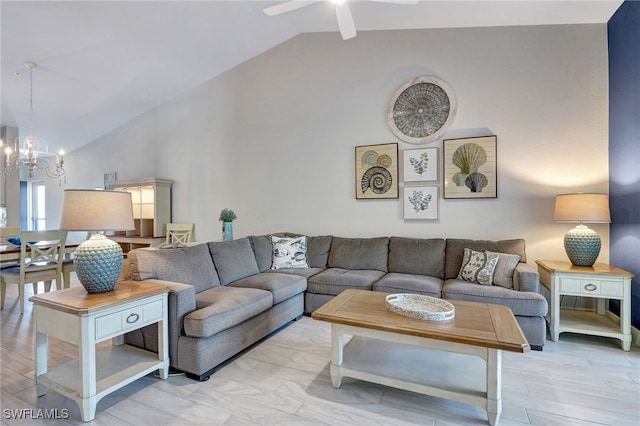 living room featuring ceiling fan with notable chandelier and lofted ceiling