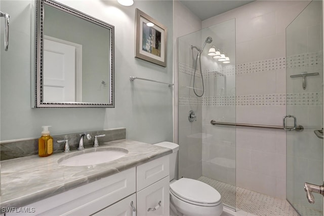 bathroom featuring vanity, toilet, and walk in shower