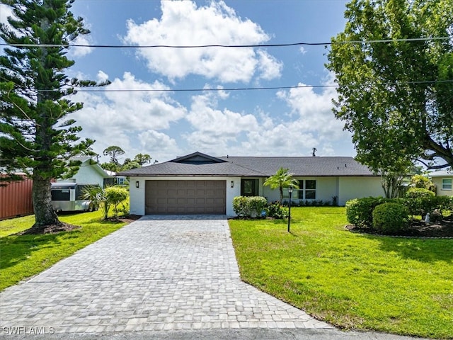 single story home featuring a front yard and a garage