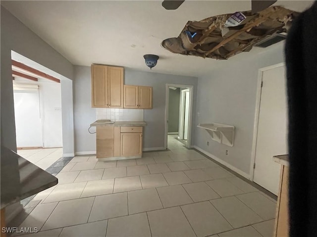 kitchen with backsplash and light brown cabinetry