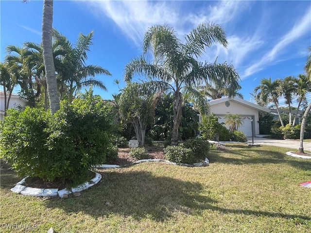 view of front of property with a garage and a front yard