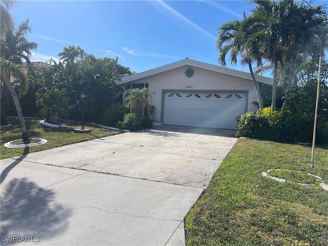 ranch-style home with a garage and a front lawn