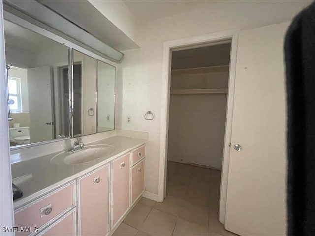 bathroom featuring vanity, tile patterned floors, and toilet