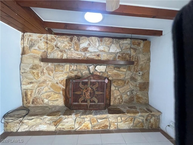 room details with beam ceiling and a stone fireplace