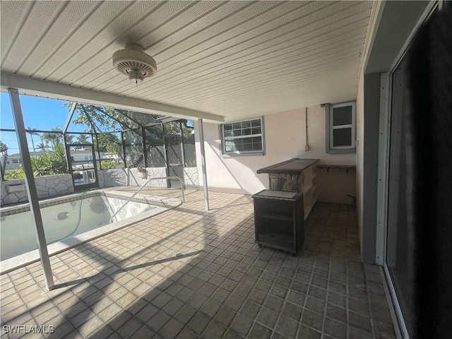 view of patio / terrace featuring glass enclosure