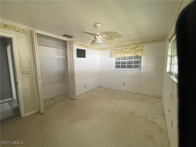 unfurnished bedroom featuring ceiling fan and a closet