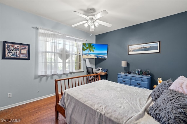 bedroom with dark hardwood / wood-style flooring and ceiling fan