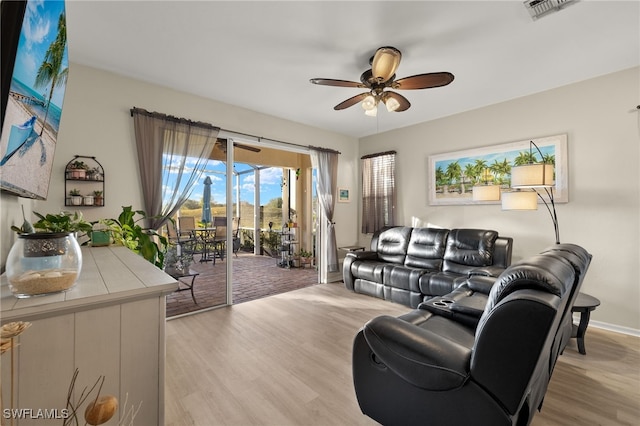 living room featuring light hardwood / wood-style floors and ceiling fan