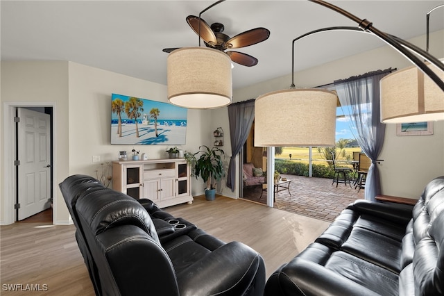 living room featuring light hardwood / wood-style floors and ceiling fan