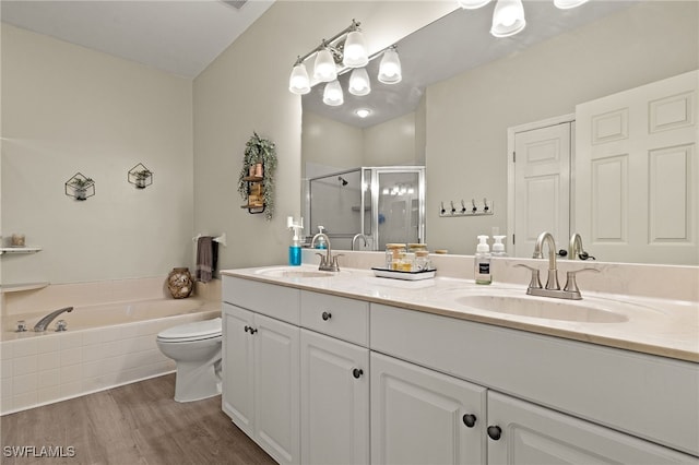 full bathroom with hardwood / wood-style flooring, vanity, toilet, and shower with separate bathtub