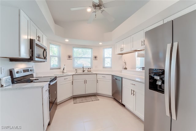 kitchen with ceiling fan, sink, white cabinets, and stainless steel appliances