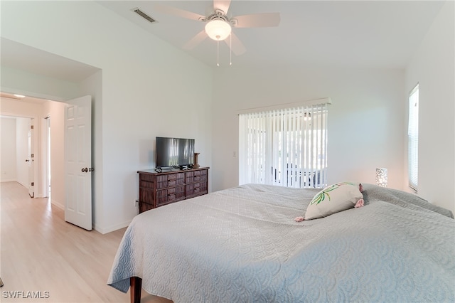 bedroom featuring multiple windows, ceiling fan, and light wood-type flooring