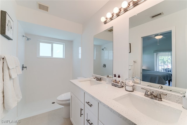 bathroom featuring tile patterned floors, a tile shower, and a wealth of natural light