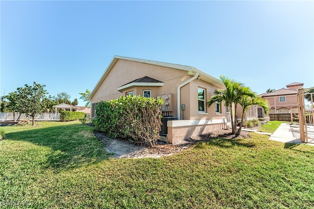 view of side of property with a lawn