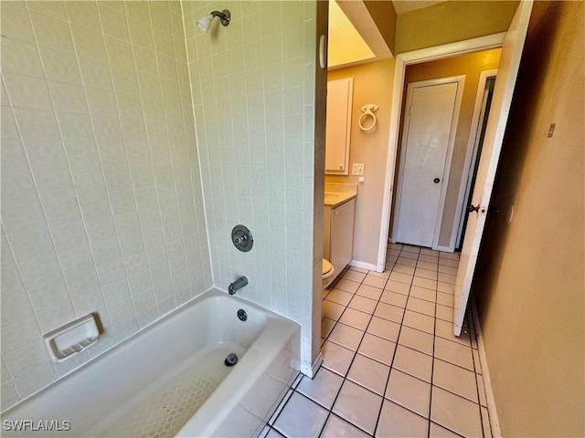 full bathroom featuring tile patterned flooring, vanity, tiled shower / bath combo, and toilet