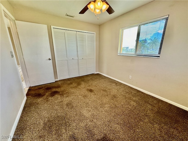 unfurnished bedroom with carpet flooring, ceiling fan, and a closet