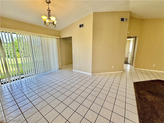 tiled spare room with a chandelier and lofted ceiling