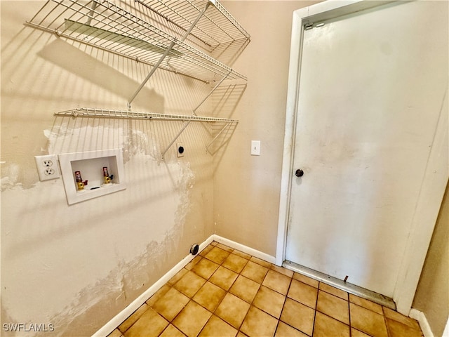 clothes washing area featuring electric dryer hookup, tile patterned floors, and hookup for a washing machine