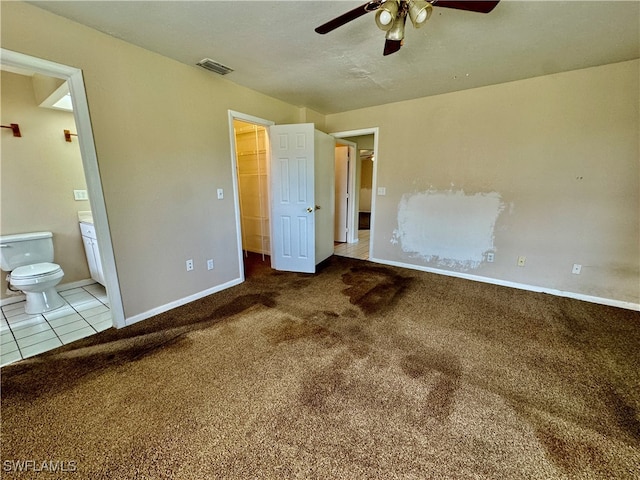 unfurnished bedroom featuring carpet flooring, connected bathroom, and ceiling fan