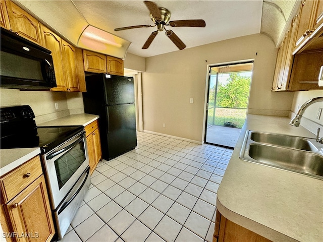 kitchen featuring light tile patterned floors, sink, ceiling fan, and black appliances