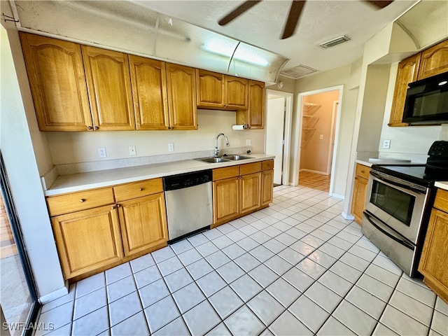 kitchen with sink, ceiling fan, light tile patterned floors, a textured ceiling, and appliances with stainless steel finishes