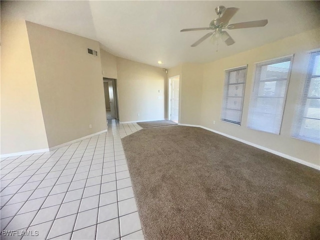 tiled spare room with lofted ceiling and ceiling fan