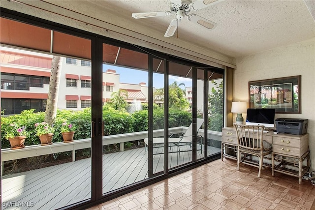 entryway with ceiling fan and a textured ceiling