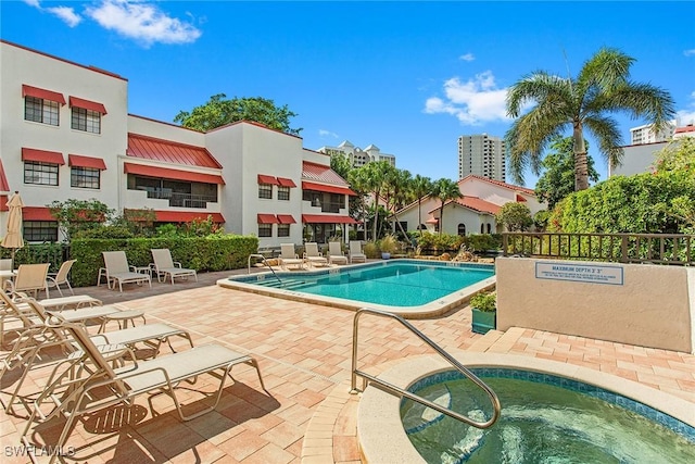 view of pool featuring a community hot tub and a patio