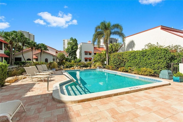 view of swimming pool featuring a patio