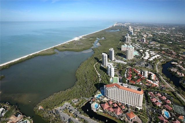 drone / aerial view featuring a water view and a view of the beach