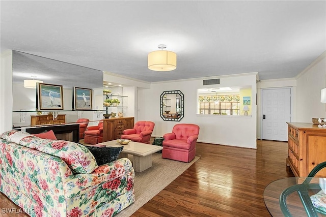 living room with dark hardwood / wood-style floors and crown molding