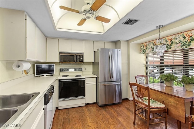 kitchen with dishwashing machine, decorative light fixtures, white cabinetry, stainless steel refrigerator, and electric range