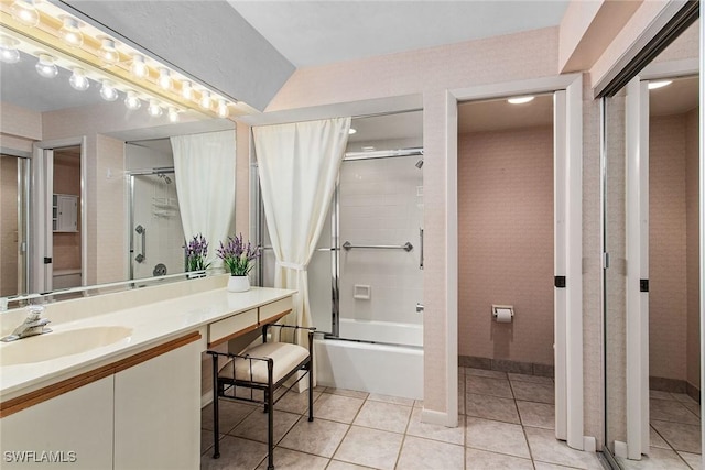 bathroom featuring combined bath / shower with glass door, tile patterned flooring, and vanity