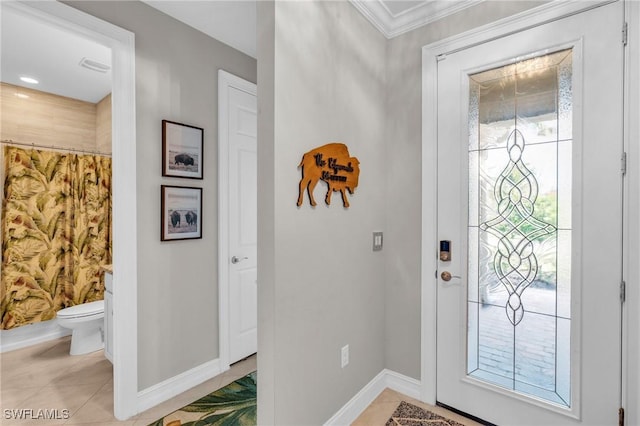 tiled entrance foyer with crown molding