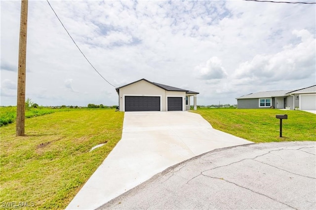 view of front of home featuring a front yard and a garage