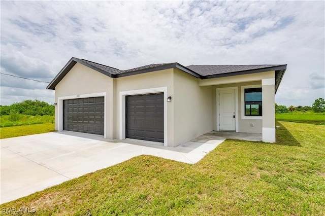 view of front of property with a front yard and a garage