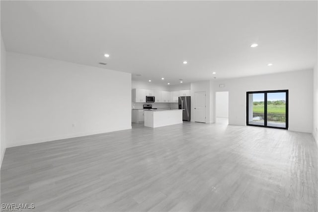 unfurnished living room featuring light wood-type flooring