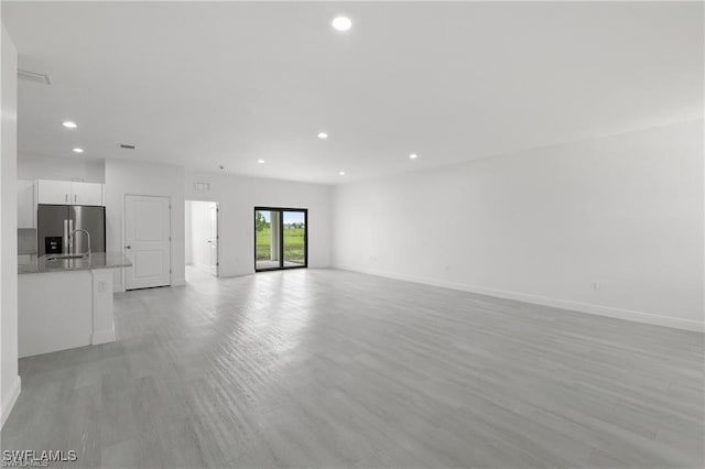 unfurnished living room with light wood-type flooring