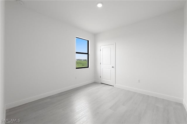 spare room with light wood-type flooring